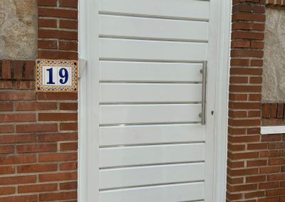 Puerta peatonal blanca aluminio soldado Aluminios Martín